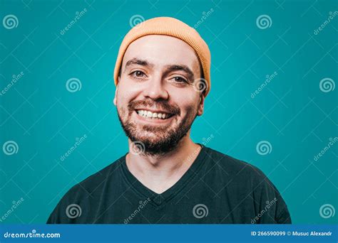 A Male Figure Dressed In A Yellow Cap In A Studio Shot With A Blue