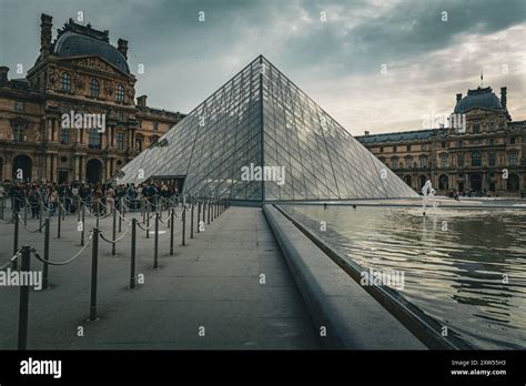 The Louvre Museum And Its Iconic Glass Pyramid In Paris France Stock