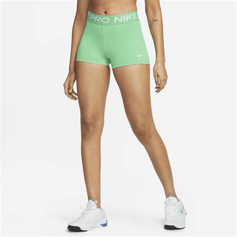 The Nike Pro Womens Shorts Are Light Green And Have White Lettering On