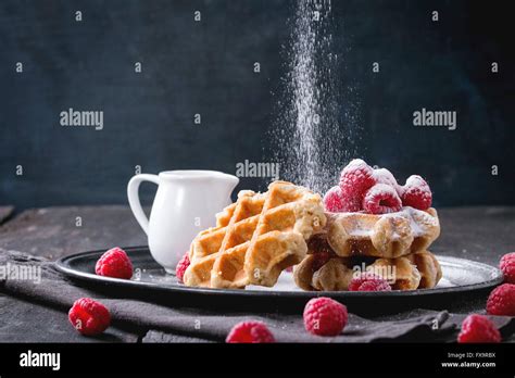 Belgian Waffles With Raspberries And Sieving Sugar Powder Served With