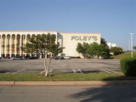 an empty parking lot in front of a building with the word folley's ...