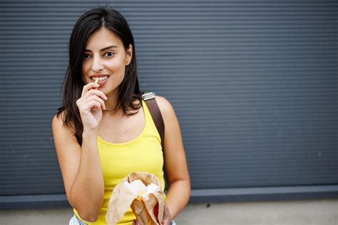 Woman Eating Fast Food In The City Stock Photo Download Image Now