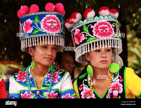 Chinese Ethnic Minorities Wearing Their Traditional Garb Wait To Dance In A Park In Kunming The