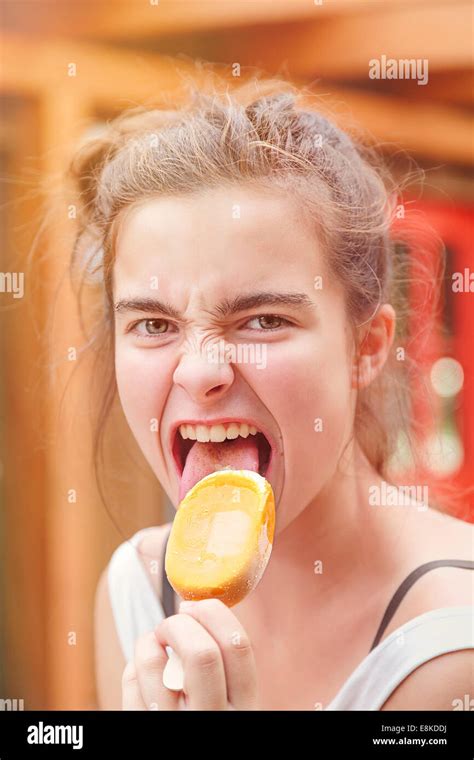 Portrait Of An Eager Teenage Girl Eating Popsicle Stock Photo Alamy