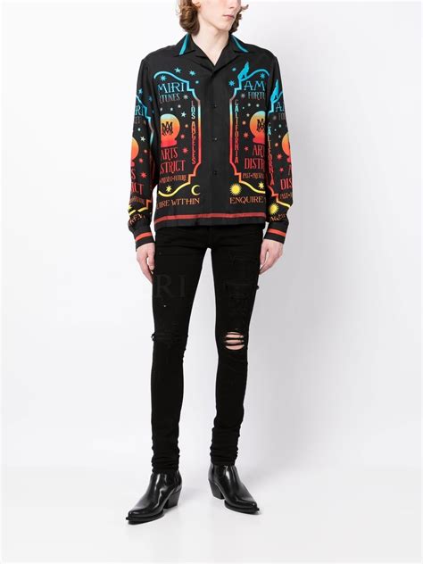 Amiri Ripped Knee Logo Print Skinny Jeans Farfetch