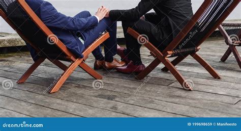 Newlywed Stylish Gay Couple On Their Happy Wedding Day Wearing Black And Blue Suits Stock Image