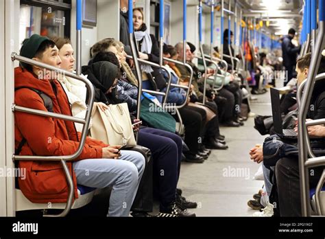 People In A Metro Train Passengers Seating With Smartphones Interior