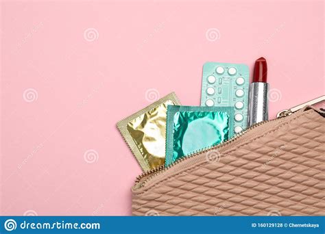 Condoms Birth Control Pills And Lipstick In Purse On Background Top