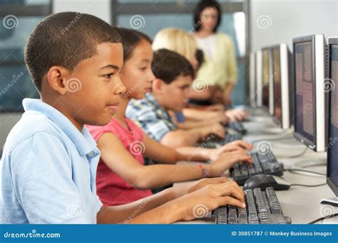 Elementary Students Working At Computers In Classroom Stock Image