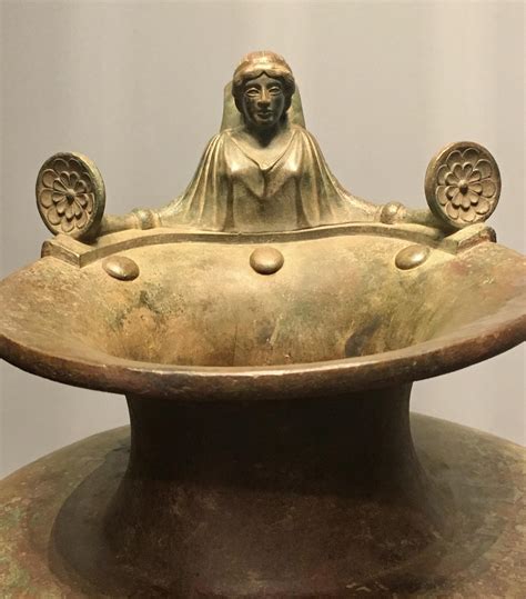 A Female Bust Tops This Bronze Greek Hydria A Three Handled Vessel