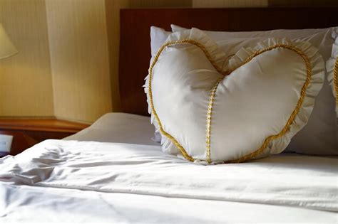 Premium Photo Heart Shape Pillow On Bed At Home