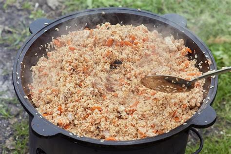 Premium Photo Cooking Food Or Pilaf In A Cauldron On Fire Cooking In