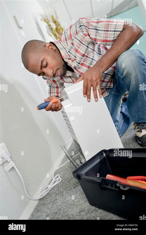 Man Fixing An Air Conditioning Unit Stock Photo Alamy