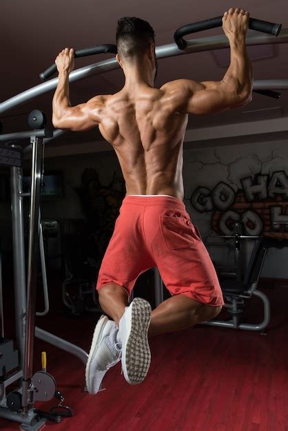 Premium Photo | Bodybuilder doing pull ups best back exercises