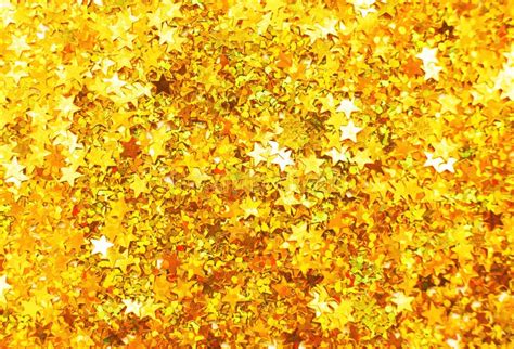 Glittering Background Of Golden Sequins In Form Of Stars Closeup