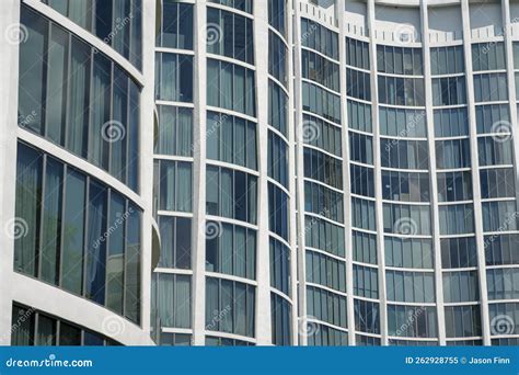 Close Up Of A Modern Building Exterior With Curved Walls With Tall Glass Windows In Miami