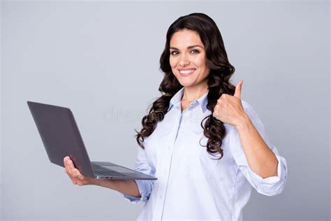 Photo Of Optimistic Brunette Wavy Young Lady Hold Laptop Show Thumb Up