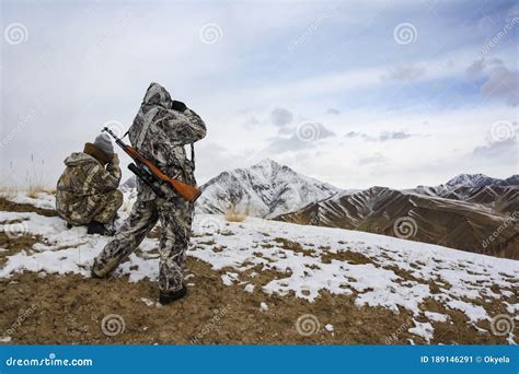 Hunters in the Mountains in Winter Camouflage Watching through ...