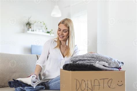 Woman Holding Cardboard Donation Box Full With Clothes Concept Of