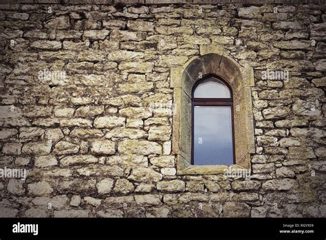 gothic window on old castle wall, textural image of historic building ...