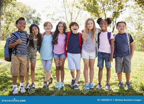 School Kids Stand Embracing in a Row Outdoors, Full Length Stock Image ...