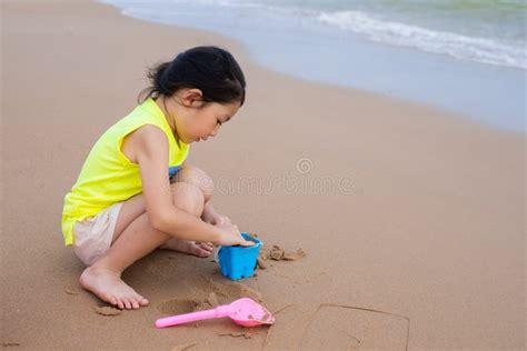 A Young Girl Playing Sand At The Beach Stock Photo Image Of Happy