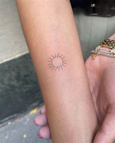 Fine Line Sun Tattoo On The Inner Forearm