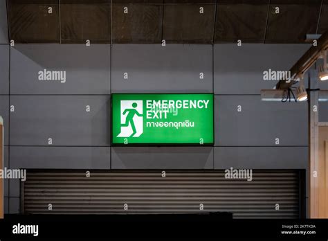 Large Emergency Exit Sign Green Light Box Is Placed On The Wall Of