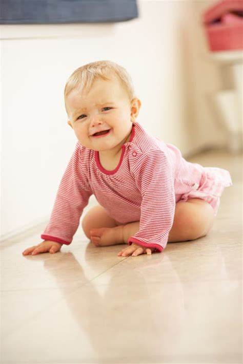 Unhappy Baby Girl Sitting On Floor Crying Stock Image Image Of Indoor