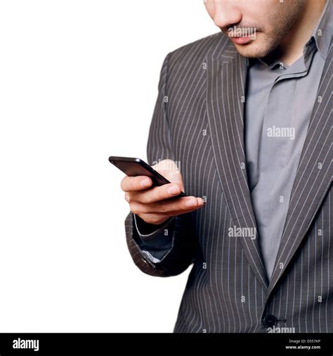 Smiling Young Man Looking At His Smart Phone While Text Messaging