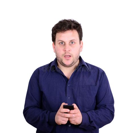 Shocked Businessman Looking At Cell Phone Against White Background