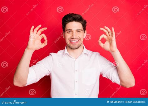 Portrait Of Attractive Guy Showing Ok Sign Smiling Wearing White Shirt