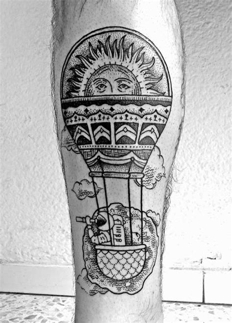 a black and white photo of a person with a hot air balloon tattoo on ...