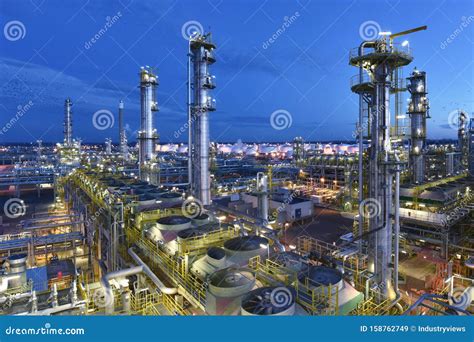 Refinery Chemical Factory At Night With Buildings Pipelines And