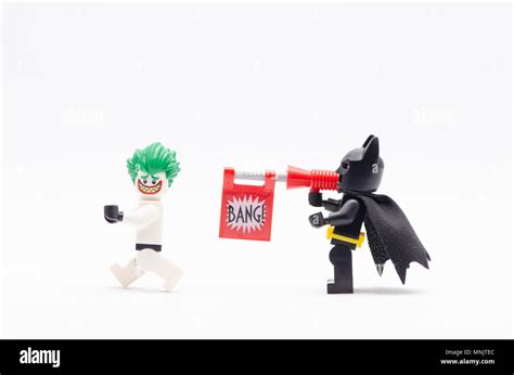 mini figure of batman with bang gun aiming shot to joker in storm ...