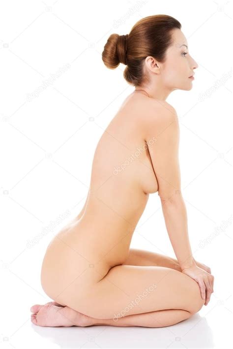 Side View Of Nude Woman Sitting On Her Knees Stock Photo Piotr