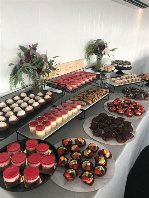 A Table Topped With Lots Of Different Types Of Cakes And Cupcakes Next