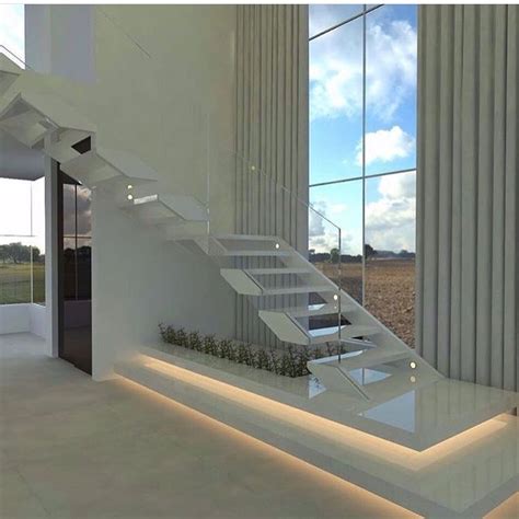 A Modern House With White Walls And Glass Stairs Leading Up To The