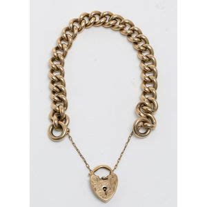 A Gold Bracelet Curb Link Design With Engraved Heart Padlock