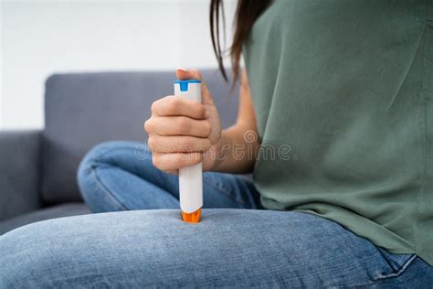 Woman Injecting Epinephrine Using Auto Injector Syringe Stock Photo