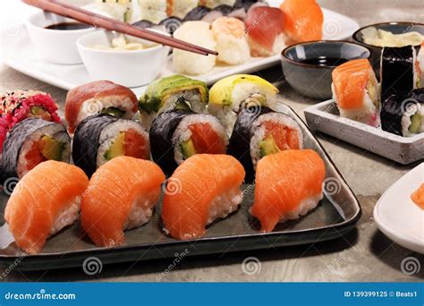 Close Up Of Sashimi Sushi Set With Chopsticks And Soy Sushi Roll With