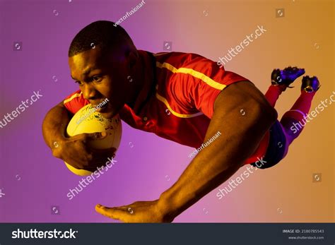 African American Male Rugby Player Jumping Stock Photo