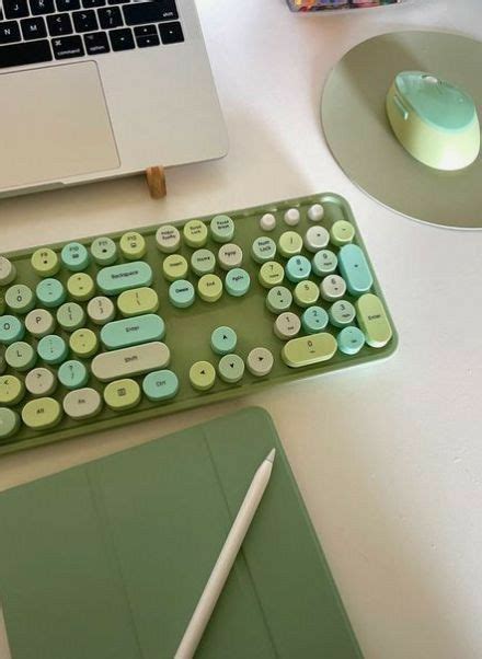 A Green Keyboard Sitting On Top Of A White Desk Next To A Laptop And Mouse