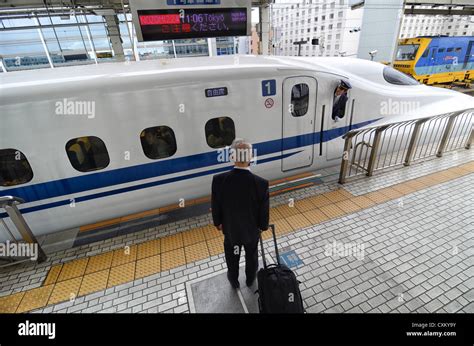 A Passenger Waits For The Doors Of A Bullet Train To Open Stock Photo