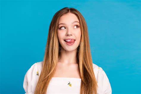 Photo Of Girl Lick Teeth Look Empty Space Isolated Blue Color