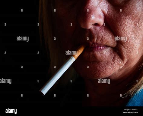 A Mature Woman Smoking A Cigarette Stock Photo Alamy