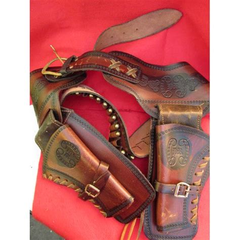 A Heavy Leather Ornately Tooled Western Gunbelt In Brown Leather With