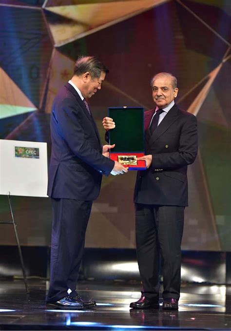 Prime Minister Muhammad Shehbaz Sharif Presenting A Memento Of Rs 100