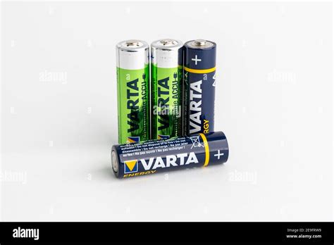 Blue Varta Batteries Versus Green Rechargeable Accus In Front Of A