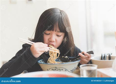 Asian Girl Eating Chashu Ramen In Japanese Restaurant Stock Image